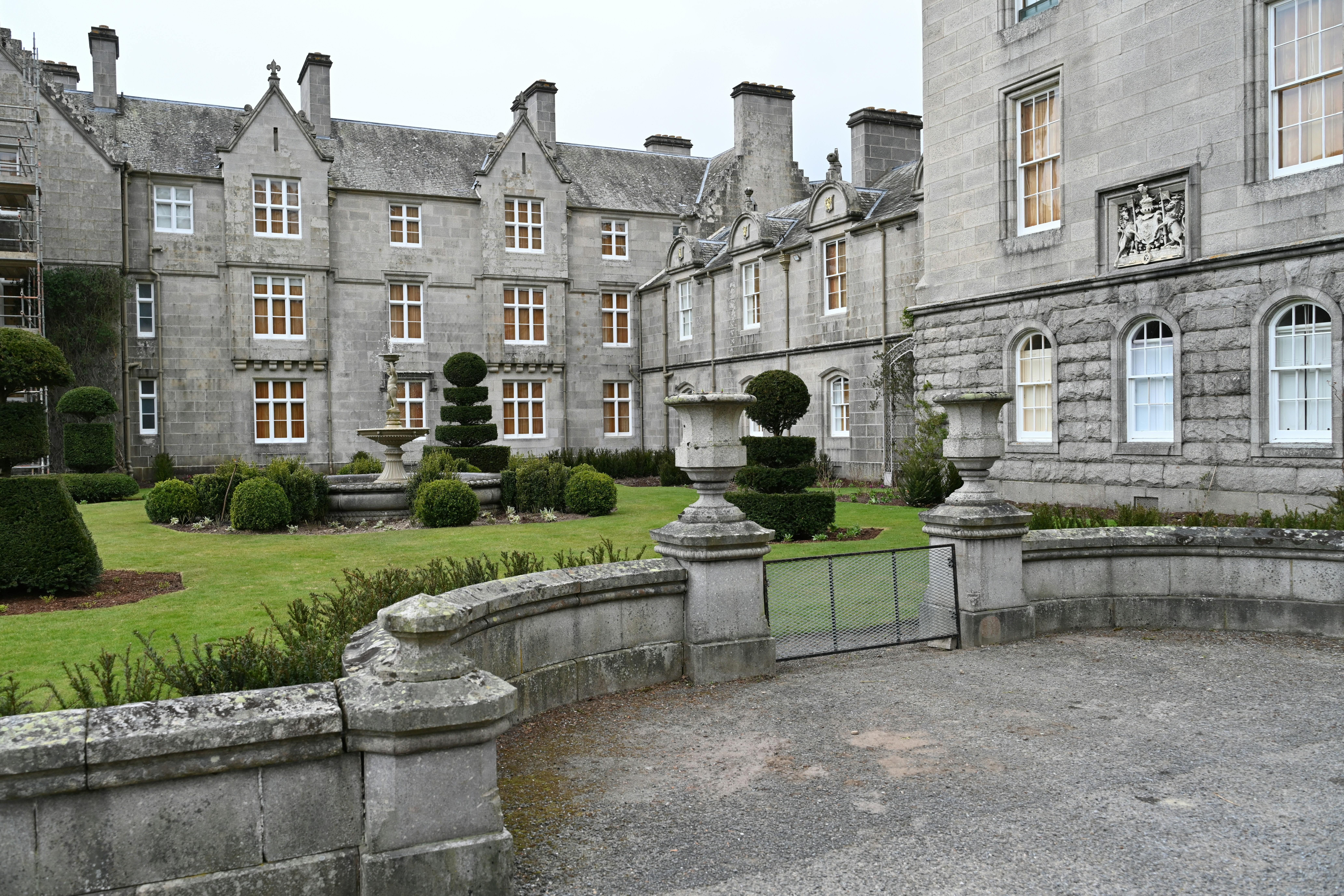 An ornate stone building with beautiful landscaping.
